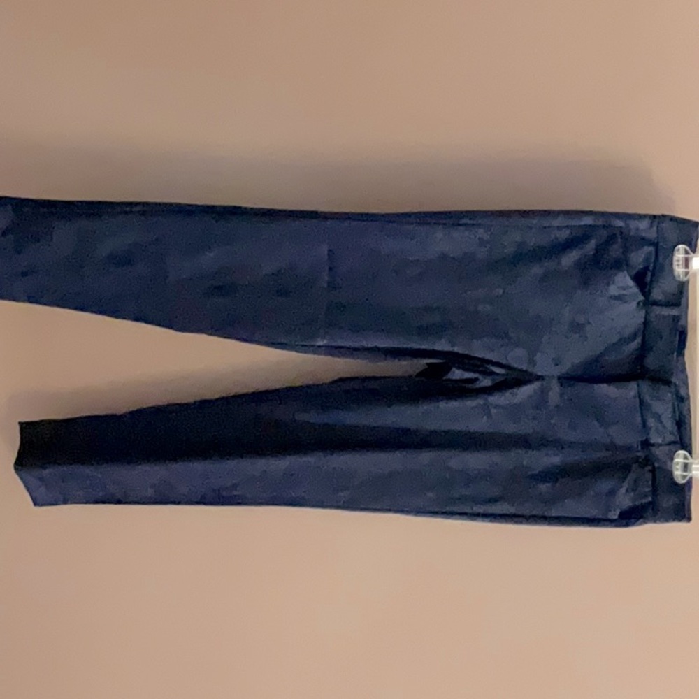 These Old Navy pants are navy blue with a floral pattern